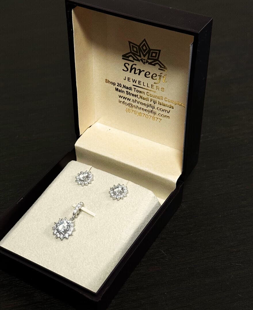 Sterling silver halo stud earrings and matching pendant in a Shreeji Jewellers gift box