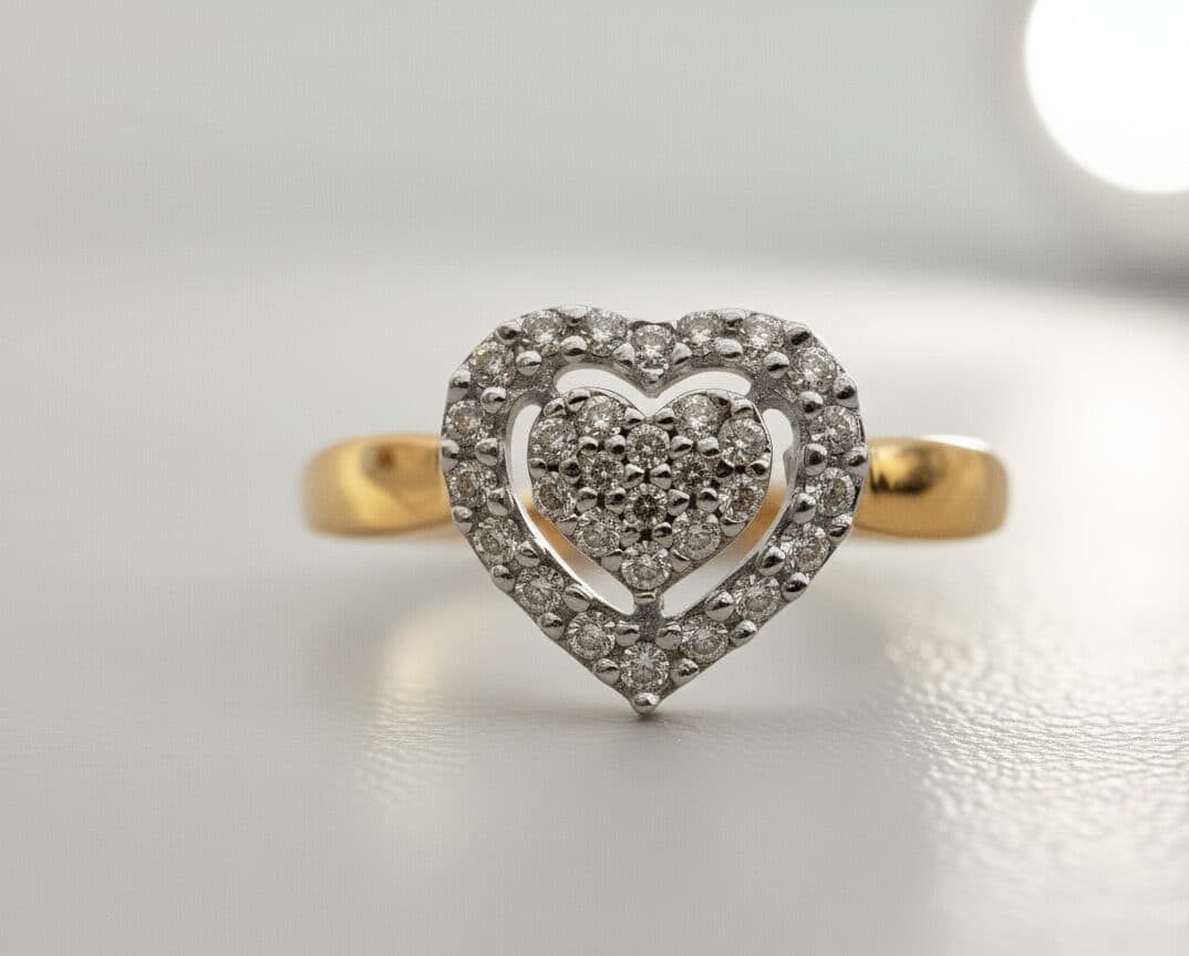 A two-tone gold ring with a heart-shaped diamond cluster inside a diamond-set heart halo