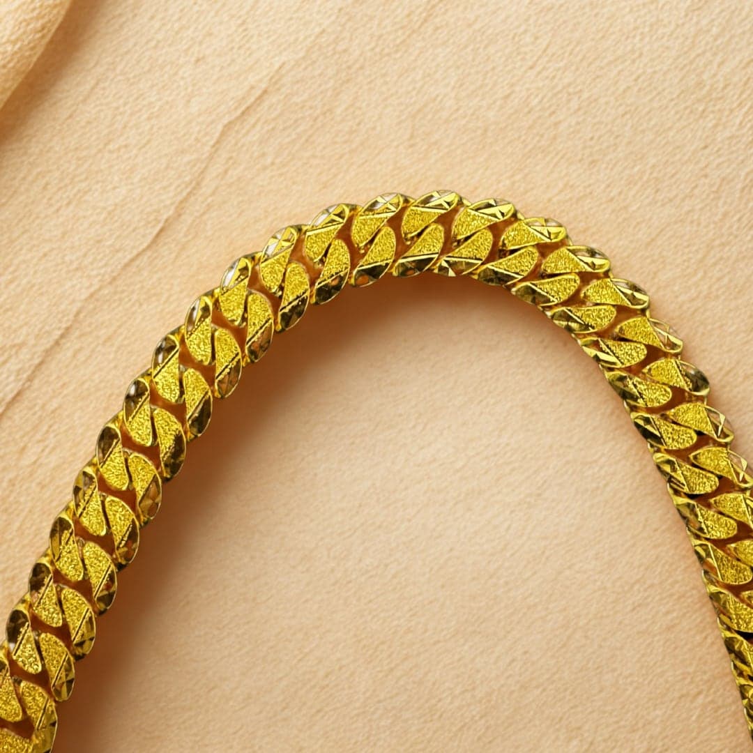 A 22ct gold curb bracelet with diamond-cut links