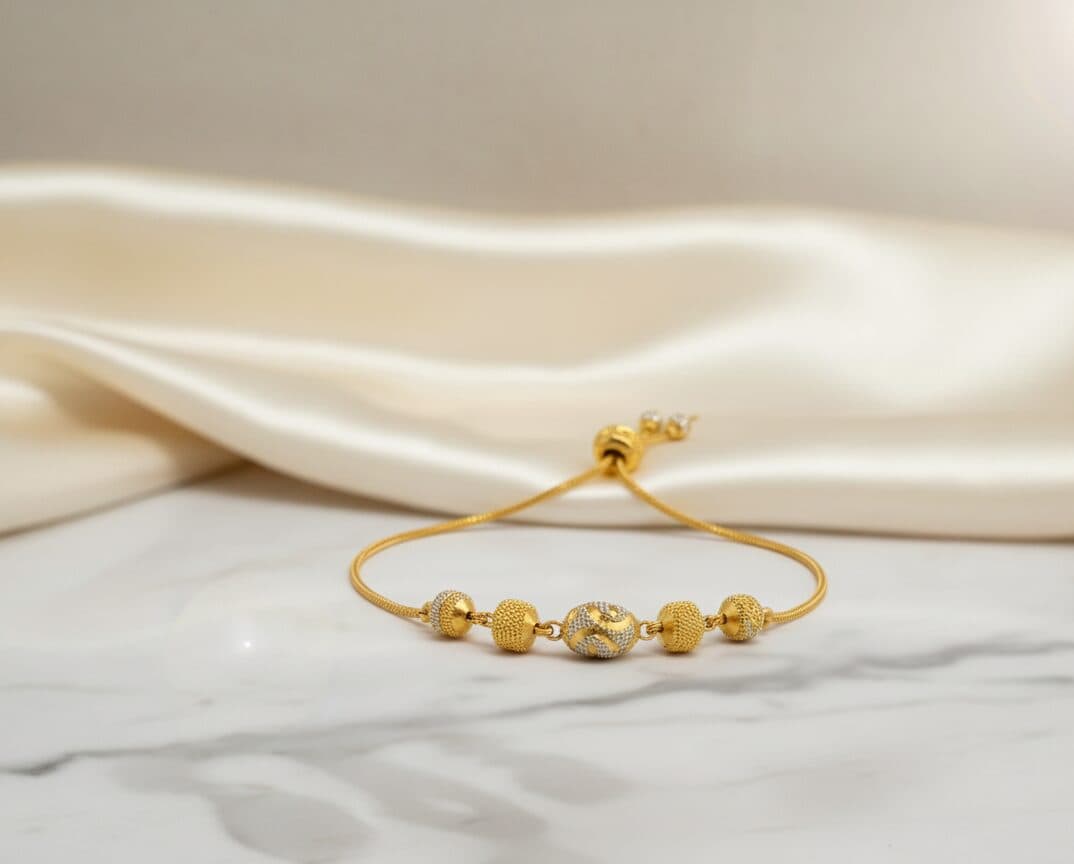 A 22ct gold adjustable bracelet with yellow and white-gold beads